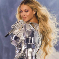 beyonce in a chrome outfit looking backwards